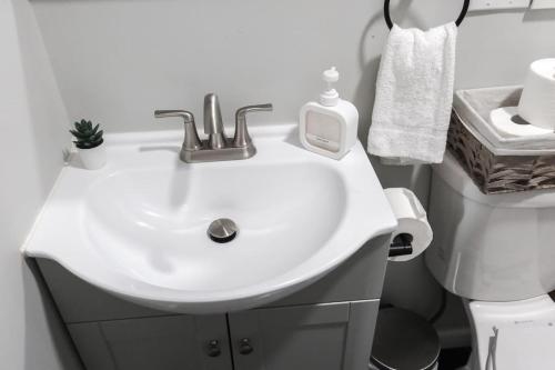 a bathroom with a white sink and a toilet at 3Bed 2Bath Apt Near NYC plus Parking and Laundry in Irvington