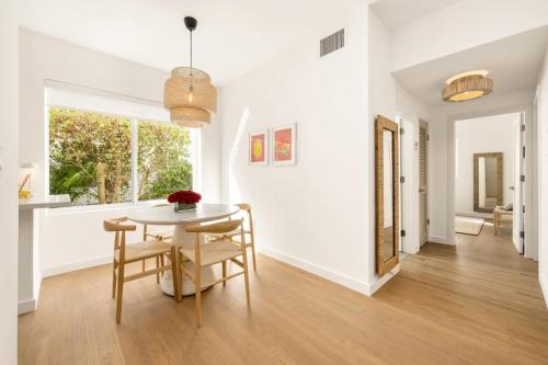 a white dining room with a table and chairs at Lux Designer Apt 2BR and 2BA in the Heart of MIA Beach in Miami Beach
