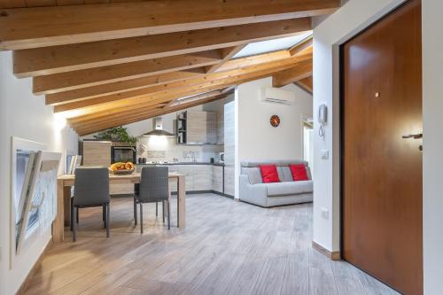 a kitchen and living room with a table and chairs at Mansarda open space in Cento