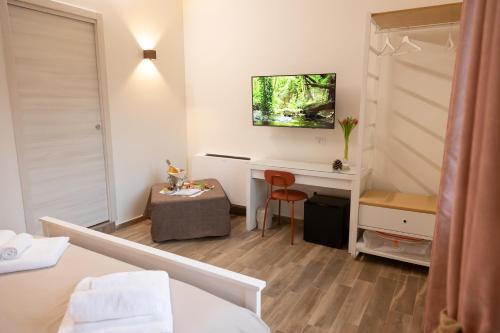 a room with a bed and a desk and a table at Casale Trifoglio in Morano Calabro