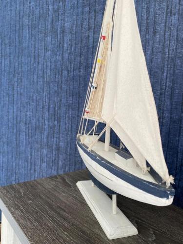a model of a sail boat sitting on a table at Esmeralda apartment in Tarcoles