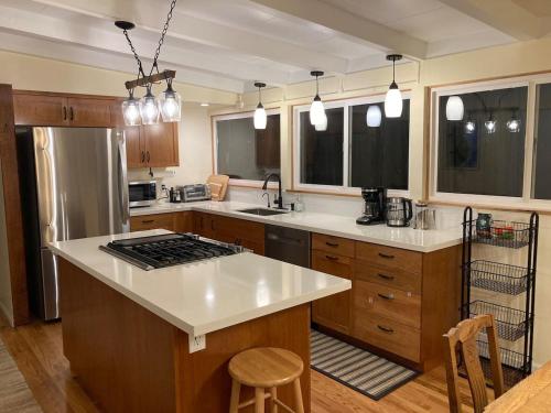 a kitchen with a stove and a counter top at Cozy Hideaway and Hot Tub. Pet Friendly. in Eureka