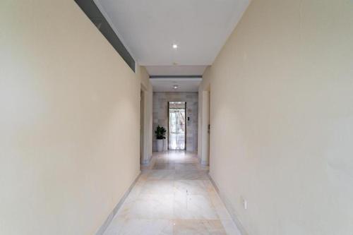an empty hallway with a white wall and a floor at Collection O Sunshine Garden Hotel - Near SECC in Ho Chi Minh City