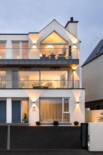 a facade of a house with lights on it at Atlantic View Portstewart in Portstewart