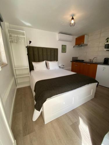 a bedroom with a large white bed in a room at Little Place Nazaré in Nazaré