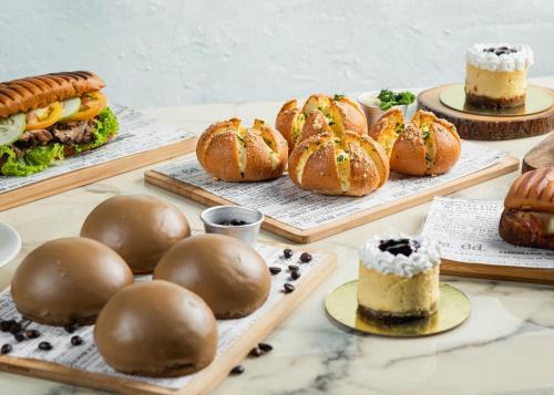 a table topped with different types of pastries and cakes at Richmonde Hotel Ortigas, Manila in Manila