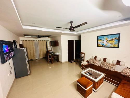a living room with a couch and a tv at Elite 7 in Guwahati