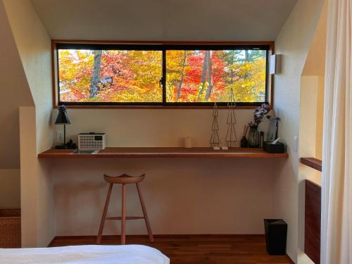 a window in a room with a stool in front of it at Karuizawa Mori Shiki VILLA - Vacation STAY 57078v in Kutsukake