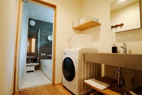 a washer and dryer in a bathroom with a sink at Karuizawa Mori Shiki VILLA - Vacation STAY 57076v in Kutsukake