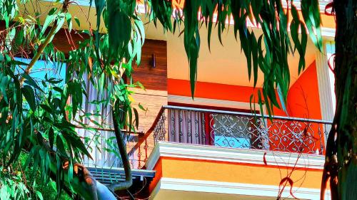 a colorful building with a staircase with plants at Apartment in Dreamland Oasis in Chakvi