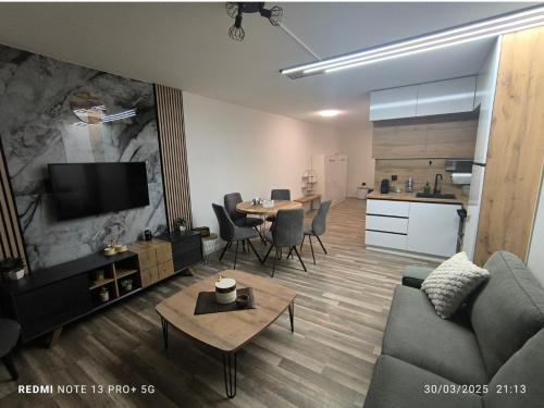 a living room with a couch and a table at Les Crêtes in Vionnaz