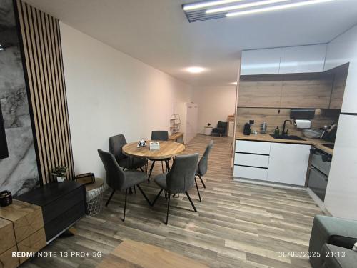 a kitchen and dining room with a table and chairs at Les Crêtes in Vionnaz