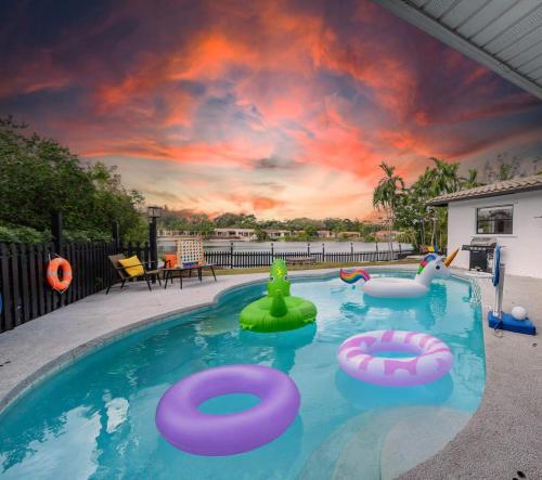a swimming pool with inflatables in a backyard at Lakefront Retreat Perfect for Family Fun in Miami