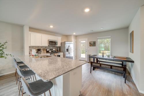 a kitchen with a counter top and a table at Family-Friendly, Pets Welcome Broken Arrow Gem! in Broken Arrow
