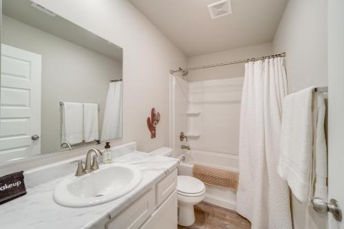 a white bathroom with a sink and a toilet at Family-Friendly, Pets Welcome Broken Arrow Gem! in Broken Arrow