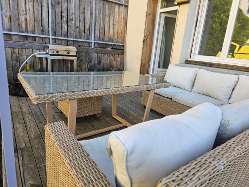a patio with a table and chairs on a deck at Logement centre ville in Maurs