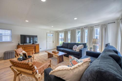 a living room with a blue couch and a tv at 221CL 221 Claressa Ave in Avalon