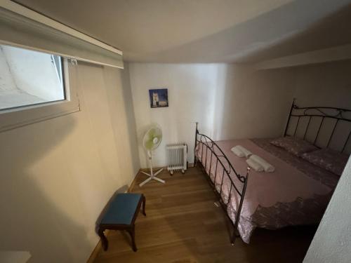 a bedroom with a metal bed and a window at Lisbon Secret & Graca Apartment in Lisbon