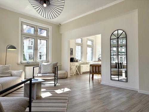 a living room with a couch and a table at HYGGE LIVING - Große hochwertige Apartments - hundefreundlich - Boxspringbetten - inmitten der Altstadt in Goslar