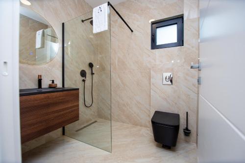 a bathroom with a shower with a toilet and a sink at Villa Aurora Azure - Luxury Infinity Pool Resort in Katun