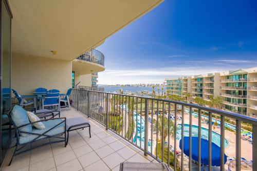 a balcony with chairs and a view of the ocean at Phoenix on the Bay 1429 condo in Orange Beach