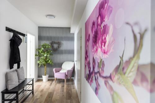 a room with a pink flower painting on the wall at Deluxe Appartements am Münster in Freiburg im Breisgau