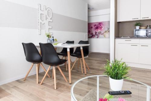 a kitchen and dining room with a table and chairs at Deluxe Appartements am Münster in Freiburg im Breisgau
