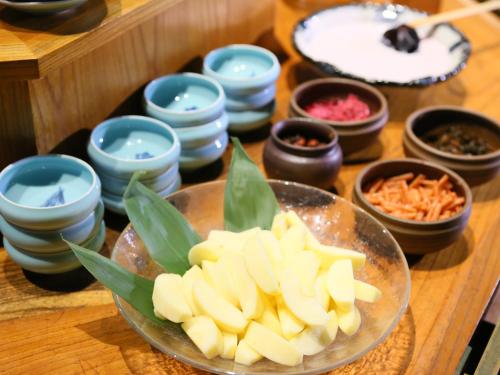 a bowl of food on a table with bowls of food at Hotel Tamanoyu in Matsumoto