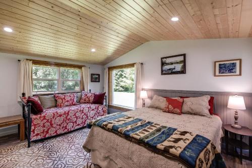 a bedroom with a bed and a couch at Making lasting memories while enjoying this unique glamping experience in Maple Falls