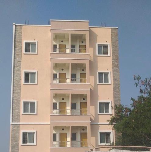 a tall building with balconies on the side of it at Mannat Enclave in Haidar Sāhibgūda