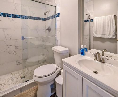 a white bathroom with a toilet and a sink at 2 Bedroom 2 Bathroom Inside the Loop in Houston
