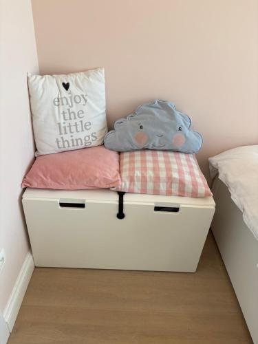 a white chest with a pillow on top of it at Luxury apartment, private terrace & FREE PARKING in Antwerp