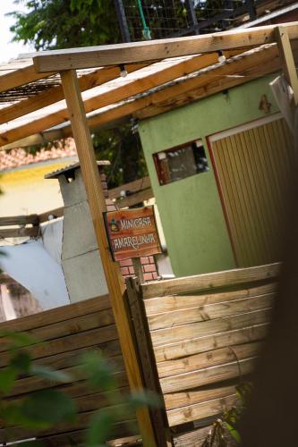 a building with a door with a sign on it at Minicasa Brasileira in Sorocaba