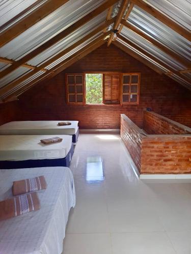 Postel nebo postele na pokoji v ubytování Chalé Magia no Recanto Shambala