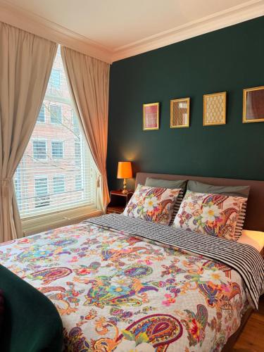 a bedroom with a large bed and a window at COMFORTABLE STYLISH ROOM in city centre of The Hague - HOME STAY in The Hague