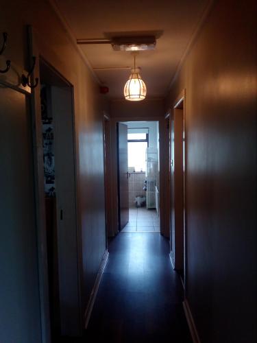 an empty hallway with a light on the ceiling at Artisthostel Letterkenny in Letterkenny