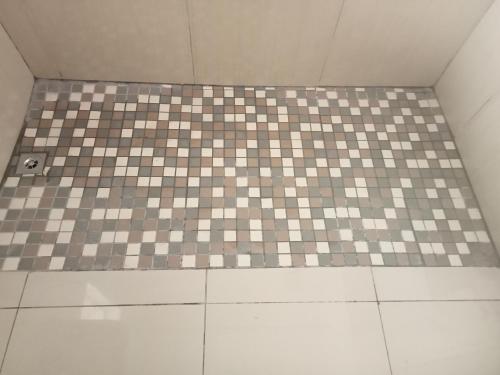 a bathroom with a checkered floor and a shower at ATHOME BELLVILLE Chrismar in Cape Town