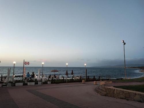a view of the ocean from a beach at dusk at Appartamento Sunset in La Ciaccia
