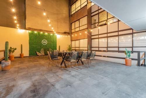 a large room with a table and chairs in it at Hipódromo Condesa Apartments by VH in Mexico City