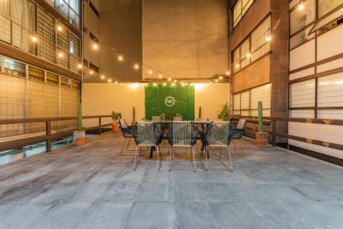a conference room with a table and chairs in a building at Hipódromo Condesa Apartments by VH in Mexico City