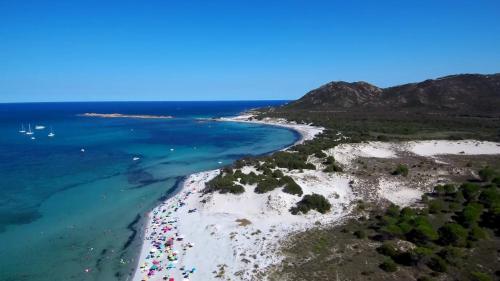 an aerial view of a beach with white sand and the ocean at Veranda with Jacuzzi & BBQ 1 minute from the Beach in Capo Comino