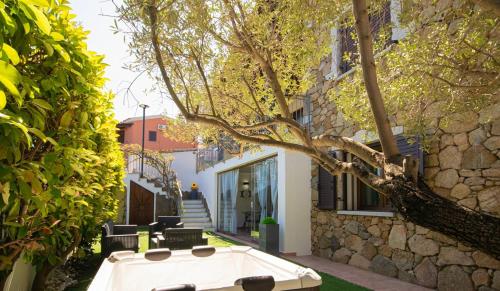 a bath tub sitting next to a stone building at Veranda with Jacuzzi & BBQ 1 minute from the Beach in Capo Comino