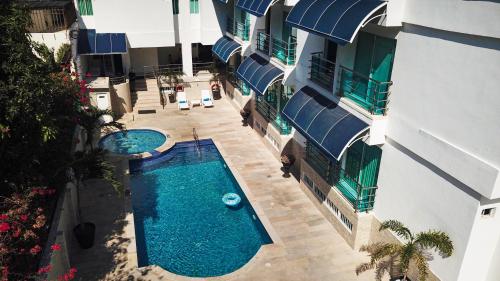 an overhead view of a building with two swimming pools at HOTEL AQUARELLA DEL MAR in Santa Marta