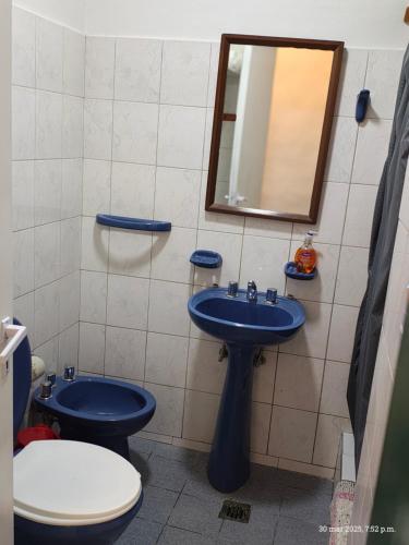 a bathroom with a blue sink and a toilet at Departamento Ciro in Playa Unión