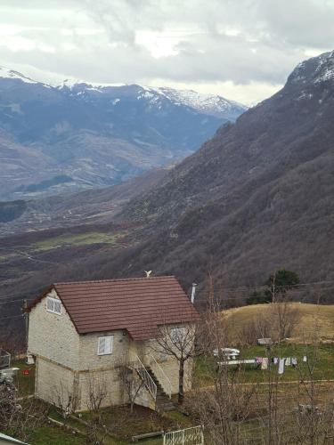a house on a hill with mountains in the background at Villa Tomorrow in Ujanik