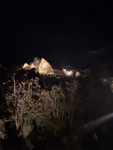 a night view of a building on top of a hill at Hotel Casa Selvaggio in Ráquira