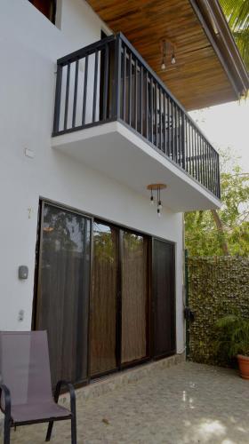 a balcony on the side of a house at Apartotel VILLA ALTA TAMARINDO in Tamarindo