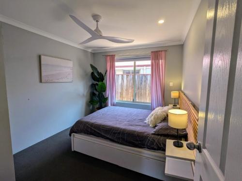 a bedroom with a bed and a window at Stableford Cottage Holiday Home Dunsborough in Dunsborough