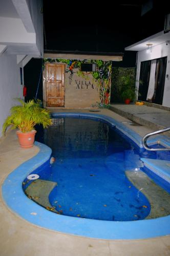 a large pool with blue water in a yard at Apartotel VILLA ALTA TAMARINDO in Tamarindo