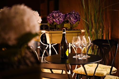 a bottle of wine sitting on a table with glasses at Solema Lake Como in Bellano